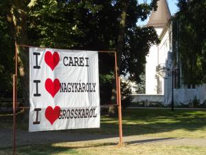 Plakat an einer Straße darauf: I (herz) CAREI I (herz) NAGYCAROLY I (herz) GROSSKAROL